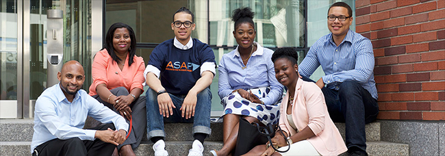 students sitting in front of school building