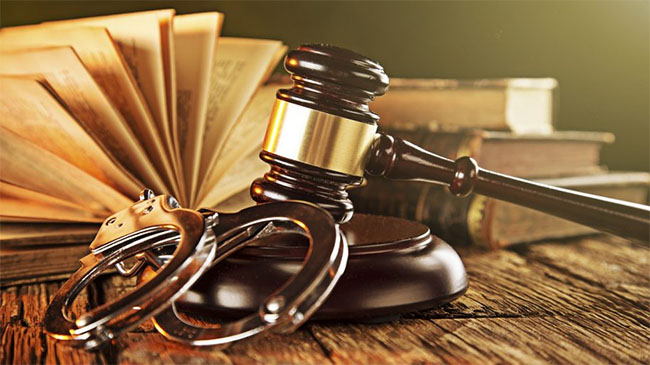 legal book, gavel and handcuffs