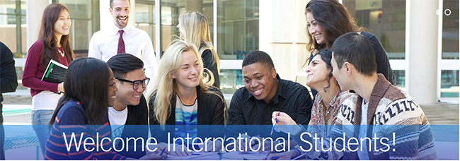 students sitting at a table on BMCC campus