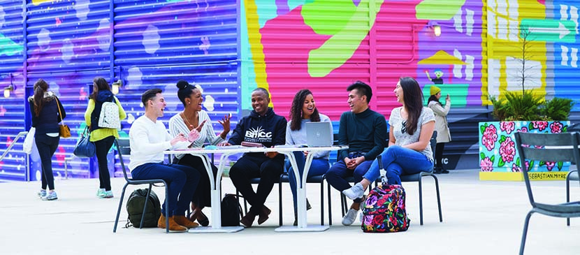 students sitting outside at table