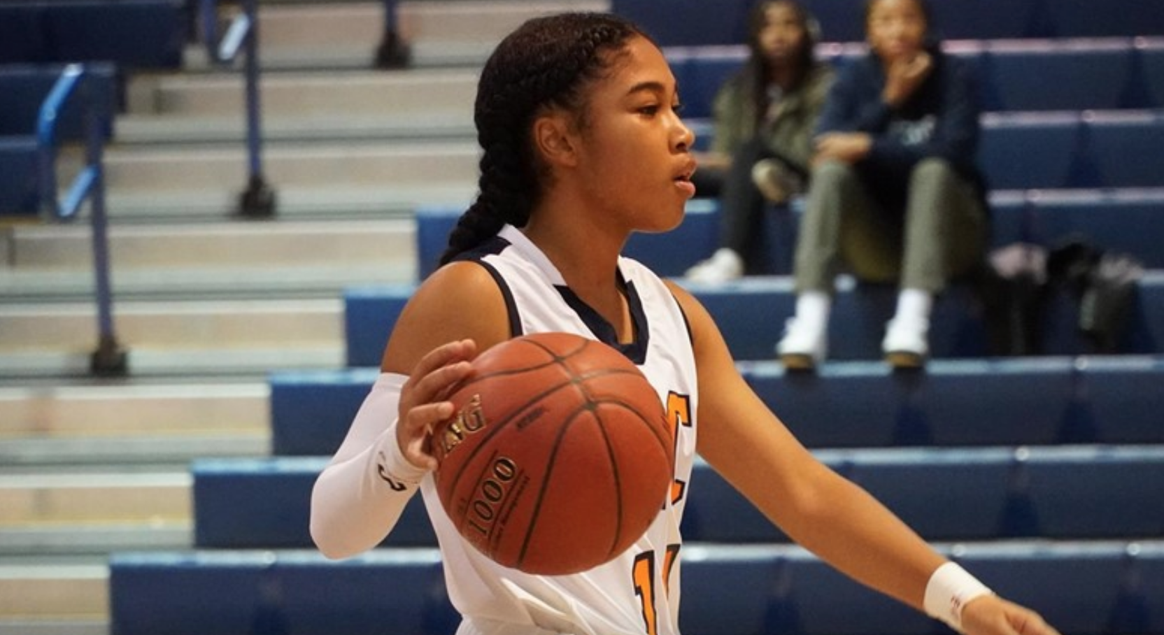 woman playing basketball in college gym