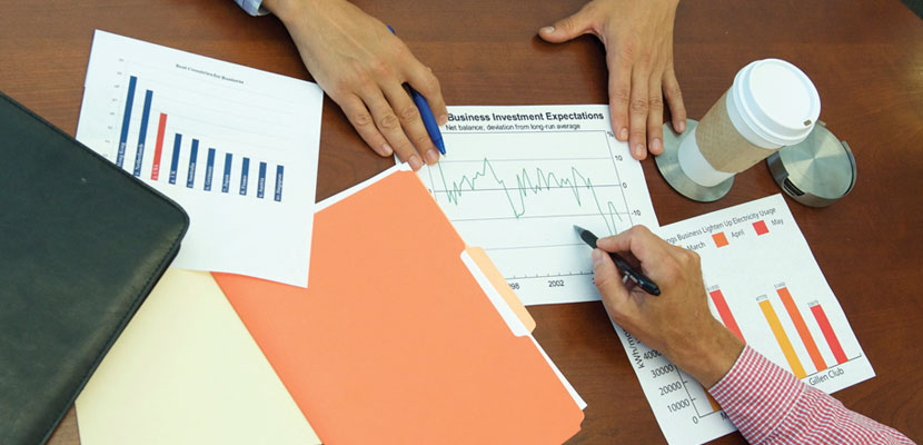 spreadsheet and folders on a table