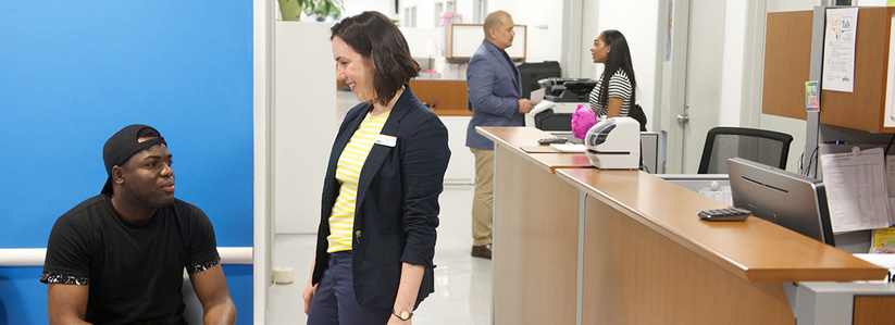 counselor greeting student in reception area of counseling center