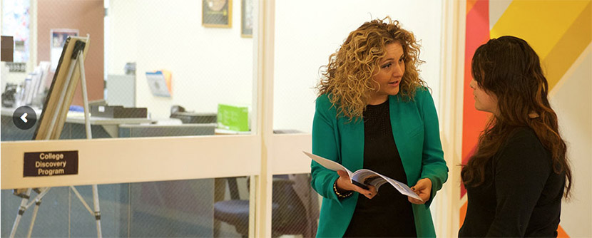 College Discovery counselor and student in front of office