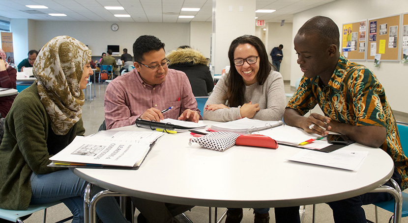 students and tutors working together at a table