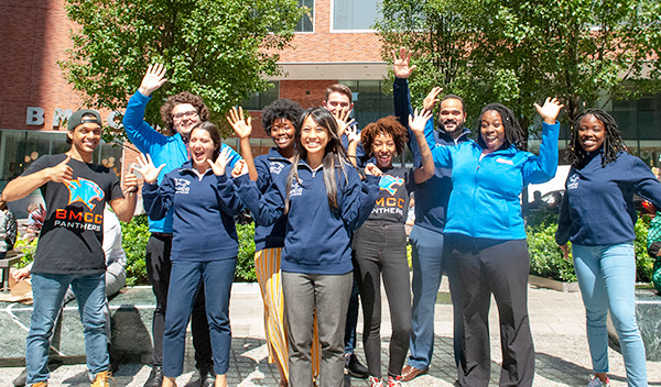 group of students waving