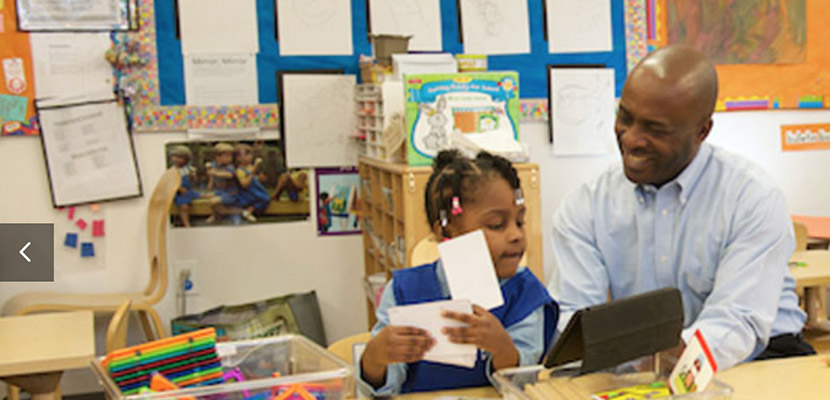 male teacher helping young student