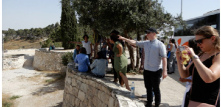 tourists and tour guide looking at scenery