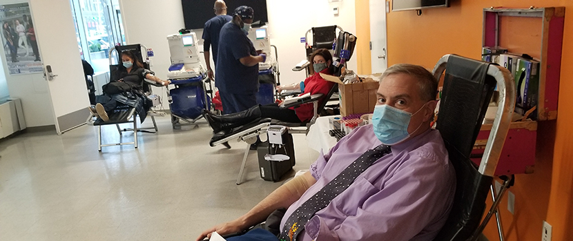 man wearing a mask waiting to donate blood