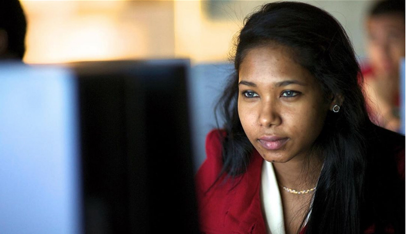 female student looking intently at computer screen