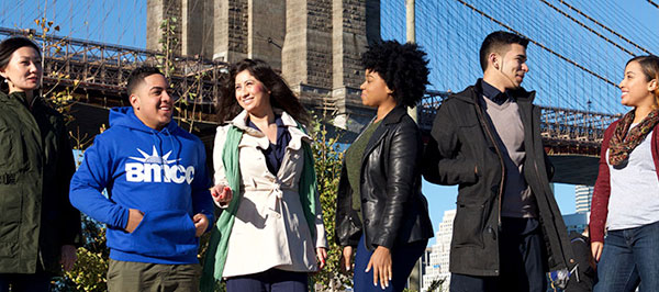 group of learning academy students standing outside school and chatting