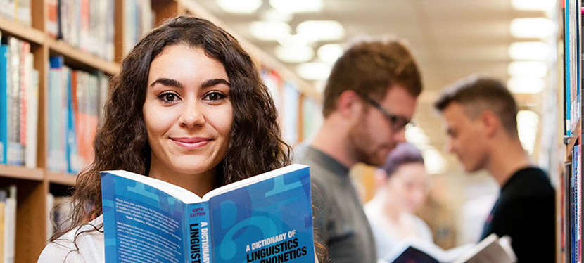 students with books in library