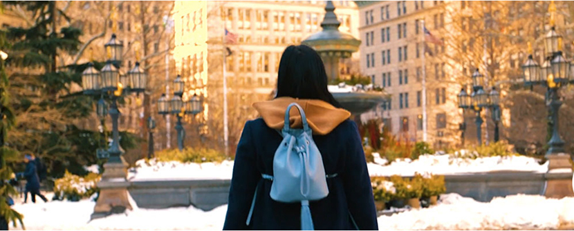 image of student with backpack looking at campus buildings