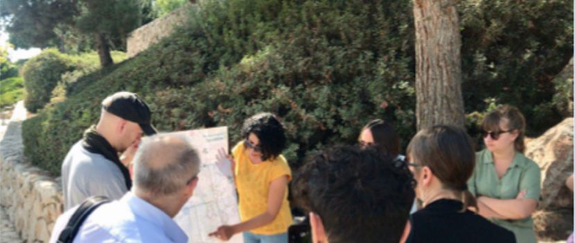 several people and a tour guide with map in a rural location