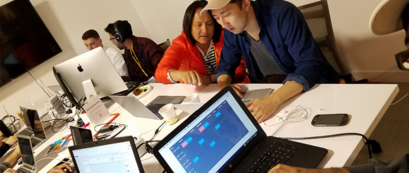 students and instructors working on laptops