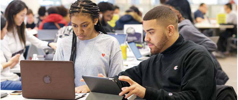 students working on projects on laptops