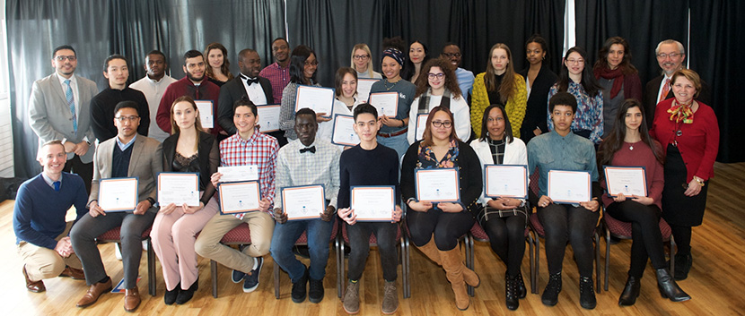 students holding their certificates from Out in Two program