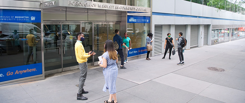 students talking in front of BMCC building