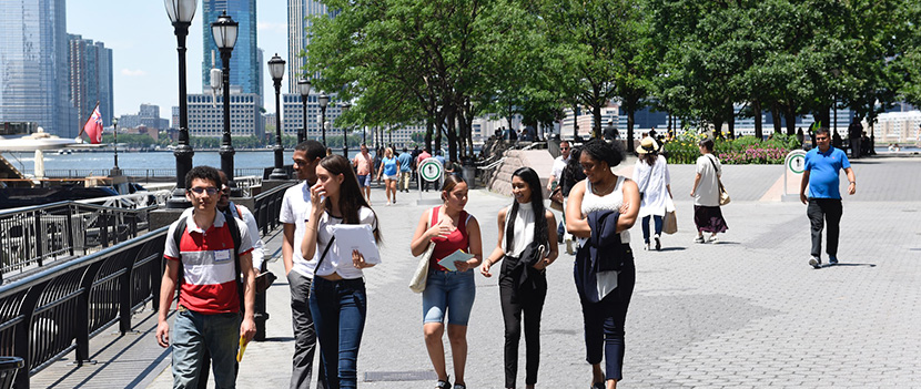 students walking on path by river