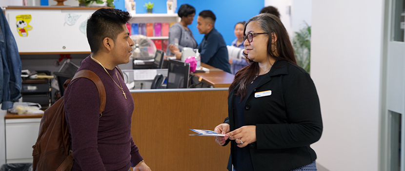 student and counselor speaking at reception desk of Counseling Center