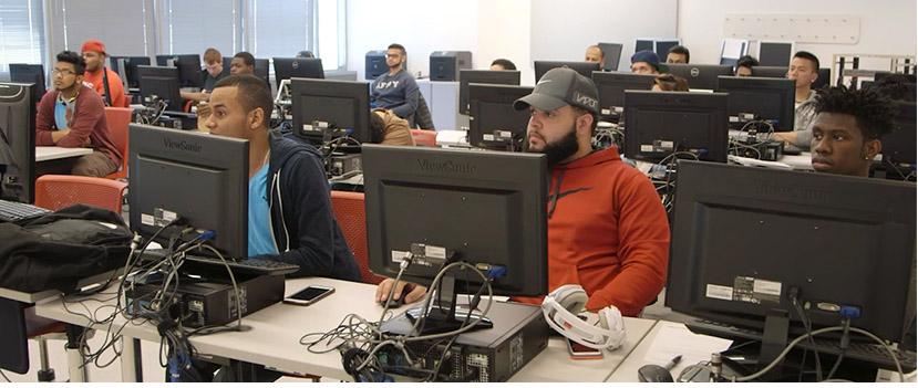 students at computers in a class