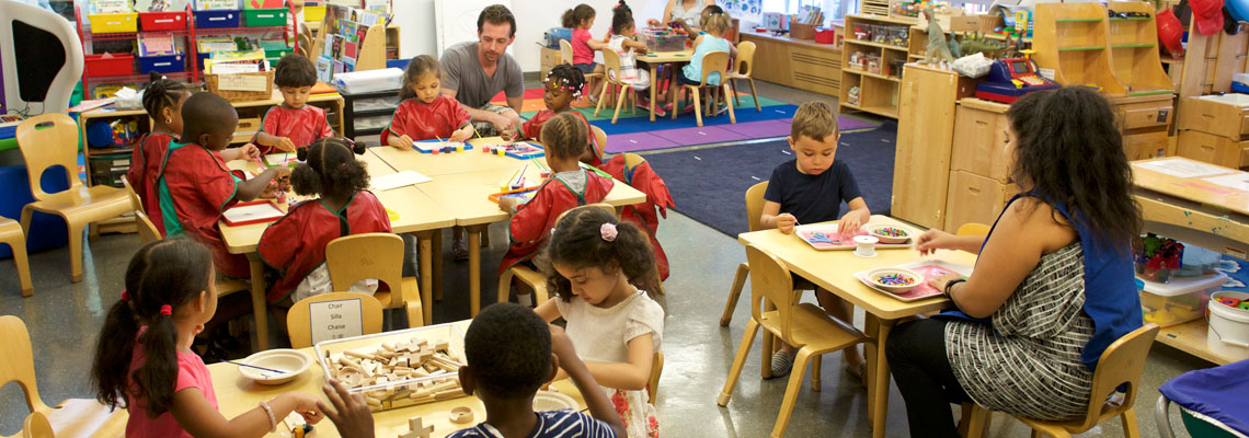 children at tables working on projects