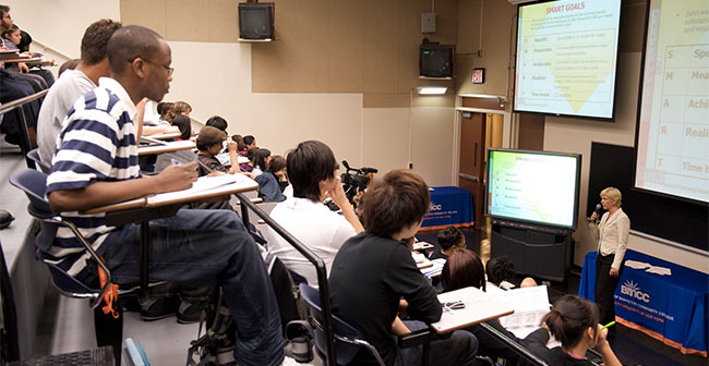 students in a lecture listening to speaker